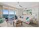 Bright living room features tile floors and balcony access with ocean views at 3315 S Atlantic Ave # 1406, Daytona Beach Shores, FL 32118