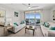Bright living room features tile floors and balcony access with ocean views at 3315 S Atlantic Ave # 1406, Daytona Beach Shores, FL 32118