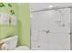 Shower with sliding glass doors, white tile, chrome fixtures, and decor at 3315 S Atlantic Ave # 1406, Daytona Beach Shores, FL 32118