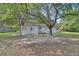 Cozy backyard features a patio, a treehouse, and mature trees offering plenty of shade at 352 Harlan Ave, Lake Helen, FL 32744