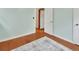Bright bedroom featuring hardwood floors and a white door at 352 Harlan Ave, Lake Helen, FL 32744