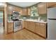 Well-equipped kitchen with stainless steel appliances, ample counter space, and wood cabinets at 352 Harlan Ave, Lake Helen, FL 32744