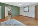 Open-concept living room with hardwood floors, a large window, and access to the kitchen at 352 Harlan Ave, Lake Helen, FL 32744