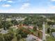 Bird's-eye view of the property in a suburban area with lush greenery, marked with a red property line at 37 Naranja Rd, Debary, FL 32713