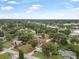 Aerial shot showcasing the property's location near a lake and local businesses, marked with a red property line at 37 Naranja Rd, Debary, FL 32713