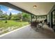 Expansive backyard with a covered patio, manicured lawn, and a charming wooden fence for privacy at 37 Naranja Rd, Debary, FL 32713