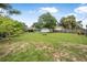 Lush, expansive backyard featuring mature trees and landscaping, bordered by a classic wooden fence for privacy at 37 Naranja Rd, Debary, FL 32713