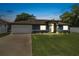 Beautiful home at twilight with well-lit exterior, lush lawn, and welcoming curb appeal at 37 Naranja Rd, Debary, FL 32713
