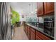 Bright kitchen featuring updated stainless steel appliances, tiled floors, and natural light from sliding glass doors at 37 Naranja Rd, Debary, FL 32713