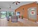 Cozy living room with tile floors, vaulted ceilings, neutral walls, and sliding glass doors to backyard at 37 Naranja Rd, Debary, FL 32713