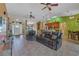 Open-concept living room with tile flooring and smooth transition into the kitchen and dining areas at 37 Naranja Rd, Debary, FL 32713