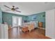 Tranquil main bedroom with hardwood floors, French doors, and a ceiling fan at 37 Naranja Rd, Debary, FL 32713