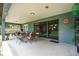 Relaxing covered patio with stylish outdoor seating, ceiling lights, and a clear view of the backyard at 37 Naranja Rd, Debary, FL 32713