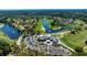 An aerial view of the community with a golf course, clubhouse, and a lake at 438 Harbour Town Ln, Ormond Beach, FL 32174