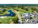 Beautiful aerial view of the golf course, lake, and clubhouse in a picturesque community at 438 Harbour Town Ln, Ormond Beach, FL 32174