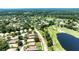 Aerial view of a community situated on a golf course with serene pond views at 438 Harbour Town Ln, Ormond Beach, FL 32174