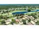 An aerial view of the property with a golf course and pond in the background at 438 Harbour Town Ln, Ormond Beach, FL 32174
