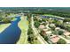 Aerial view of the home in a golf course community with surrounding lakes, trees and landscaping at 438 Harbour Town Ln, Ormond Beach, FL 32174