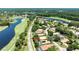 Overhead view of a single Gathering home in a golf community with well manicured greens and water features at 438 Harbour Town Ln, Ormond Beach, FL 32174