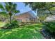 Expansive backyard featuring manicured lawn and screened-in patio for outdoor enjoyment at 438 Harbour Town Ln, Ormond Beach, FL 32174