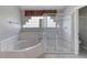 This bathroom includes a glass-enclosed shower, and a soaking tub under glass block windows at 438 Harbour Town Ln, Ormond Beach, FL 32174