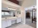 Bathroom features a double sink vanity, a large mirror, and tiled floors at 438 Harbour Town Ln, Ormond Beach, FL 32174