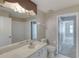 Bathroom showcasing white vanity, toilet, and passage to a tiled shower at 438 Harbour Town Ln, Ormond Beach, FL 32174