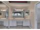 Bathroom features a double sink vanity, a large mirror, and tiled floors at 438 Harbour Town Ln, Ormond Beach, FL 32174