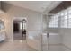 This bathroom includes a glass-enclosed shower, and a soaking tub under glass block windows at 438 Harbour Town Ln, Ormond Beach, FL 32174