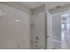 Clean, tiled shower and tub showcasing the passage to the rest of the home at 438 Harbour Town Ln, Ormond Beach, FL 32174