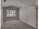 A bright bedroom featuring neutral paint and carpet, vaulted ceiling, and shuttered windows at 438 Harbour Town Ln, Ormond Beach, FL 32174