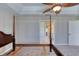 View of bedroom with four-poster bed frame leading to the bathroom at 438 Harbour Town Ln, Ormond Beach, FL 32174