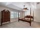 This bedroom features a four-poster bed frame and a matching chest of drawers at 438 Harbour Town Ln, Ormond Beach, FL 32174