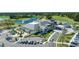 An exterior aerial view of a modern clubhouse with ample parking, beautiful landscaping and lakeside golf course at 438 Harbour Town Ln, Ormond Beach, FL 32174