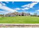 Lush putting green leading up to clubhouse featuring outdoor dining and golf cart parking at 438 Harbour Town Ln, Ormond Beach, FL 32174