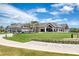 Gorgeous clubhouse view with lush putting green and golf carts lined up ready for a round of golf at 438 Harbour Town Ln, Ormond Beach, FL 32174