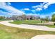 Beautiful clubhouse view with lush putting green and golf carts lined up near the putting green at 438 Harbour Town Ln, Ormond Beach, FL 32174