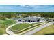 Stunning aerial view of the golf clubhouse with lush landscaping and convenient golf cart parking at 438 Harbour Town Ln, Ormond Beach, FL 32174