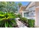 Exterior view with lush landscaping, a paved walkway, and a well-maintained front yard at 438 Harbour Town Ln, Ormond Beach, FL 32174