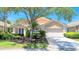 Charming single-story home featuring a neutral color palette, a two-car garage and mature landscaping at 438 Harbour Town Ln, Ormond Beach, FL 32174