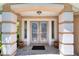 Inviting front entrance showcasing decorative glass doors and stately columns at 438 Harbour Town Ln, Ormond Beach, FL 32174