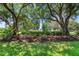 Beautiful front yard with mature trees and a manicured lawn offering plenty of natural shade at 438 Harbour Town Ln, Ormond Beach, FL 32174