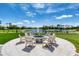 Scenic view from the outdoor patio featuring a fire pit and chairs overlooking a beautiful golf course and lake at 438 Harbour Town Ln, Ormond Beach, FL 32174