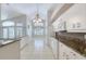 Bright kitchen with an island, white appliances, and tiled floors at 438 Harbour Town Ln, Ormond Beach, FL 32174