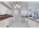 Bright kitchen with white appliances, granite countertops, and tiled floors at 438 Harbour Town Ln, Ormond Beach, FL 32174