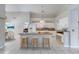 Bright kitchen features a center island with seating, white cabinets and tile flooring at 438 Harbour Town Ln, Ormond Beach, FL 32174
