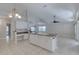 Bright kitchen features a center island, white cabinets, and tile flooring throughout at 438 Harbour Town Ln, Ormond Beach, FL 32174