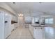 Bright kitchen features a center island, white cabinets, and tile flooring throughout at 438 Harbour Town Ln, Ormond Beach, FL 32174
