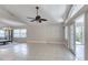 Bright living room featuring tiled floors, ceiling fan, and view of the backyard at 438 Harbour Town Ln, Ormond Beach, FL 32174