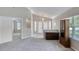 Open-concept living room with plush carpeting, natural light, and access to the foyer at 438 Harbour Town Ln, Ormond Beach, FL 32174